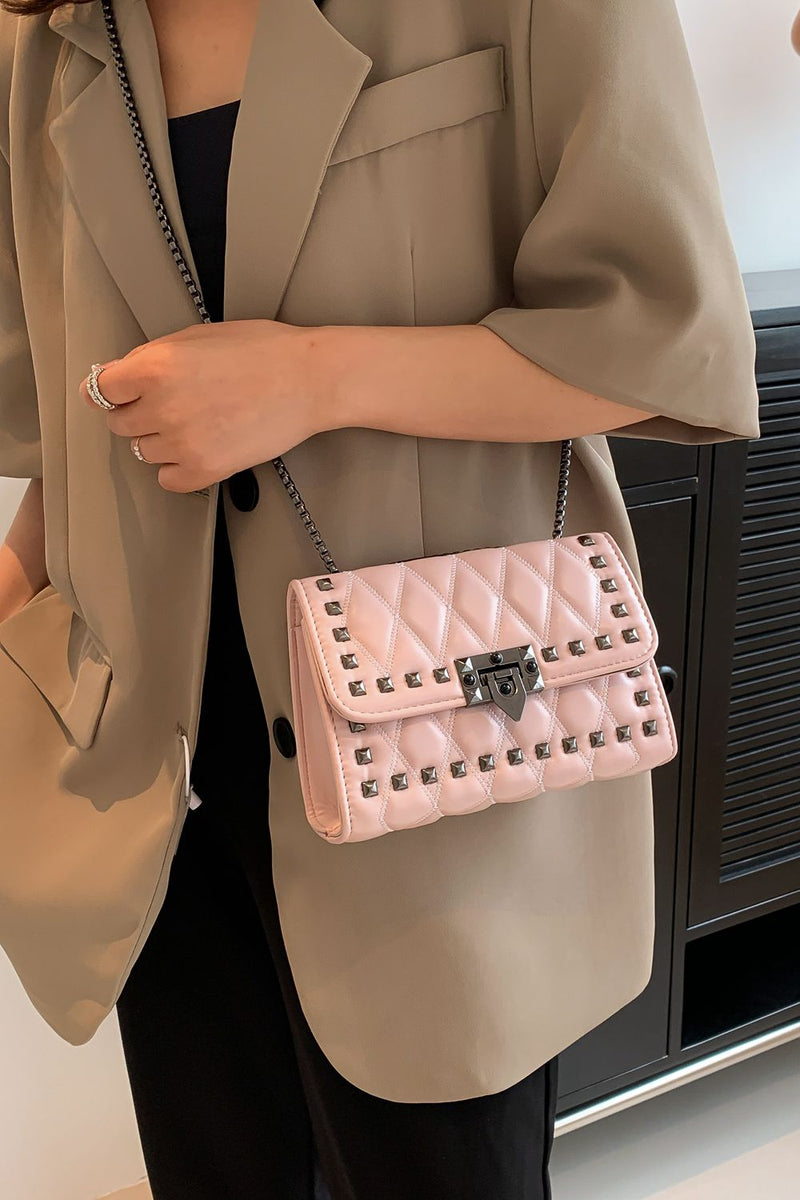 "Edgy and Chic: Studded Leather Crossbody Bag at Burkesgarb