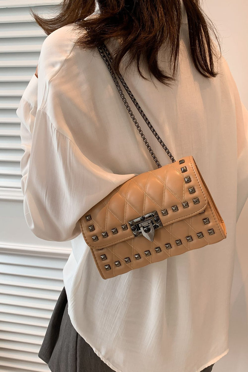 "Edgy and Chic: Studded Leather Crossbody Bag at Burkesgarb