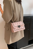 "Edgy and Chic: Studded Leather Crossbody Bag at Burkesgarb