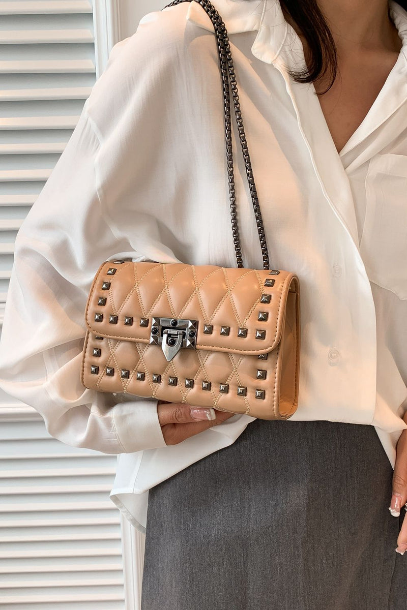 "Edgy and Chic: Studded Leather Crossbody Bag at Burkesgarb