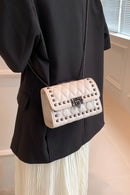 "Edgy and Chic: Studded Leather Crossbody Bag at Burkesgarb