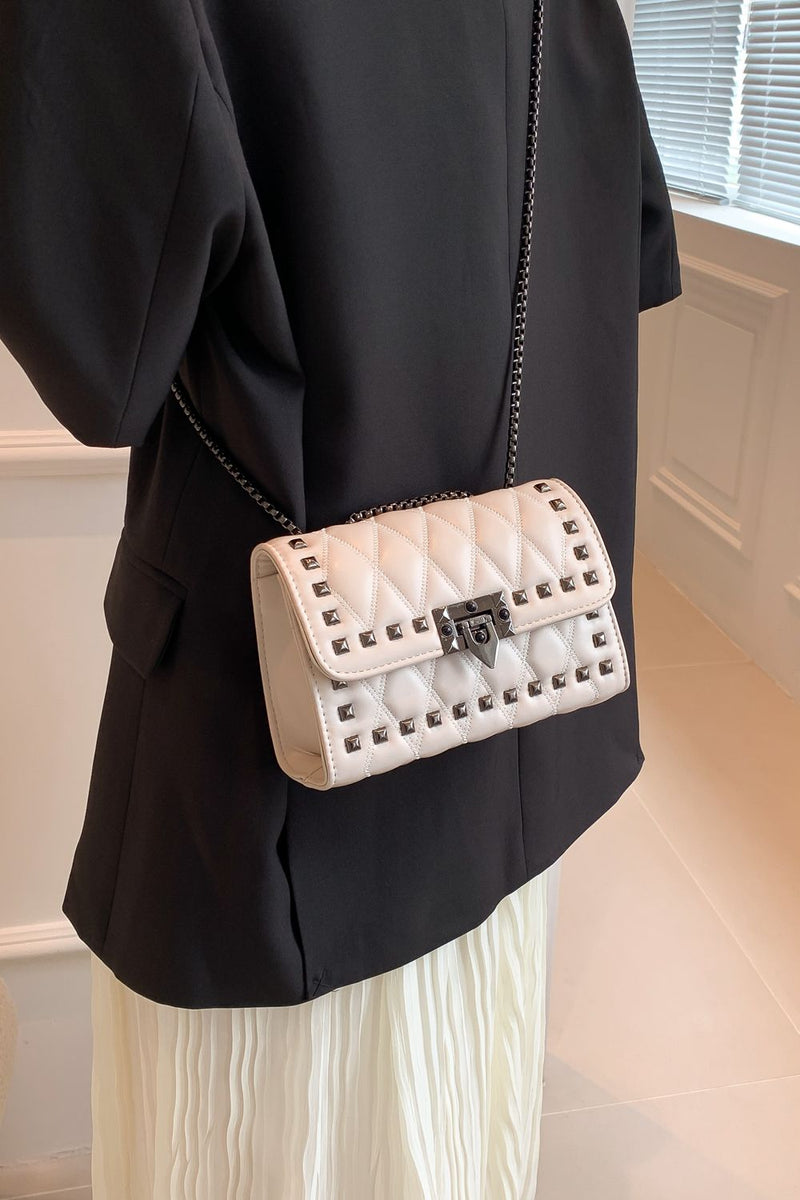 "Edgy and Chic: Studded Leather Crossbody Bag at Burkesgarb