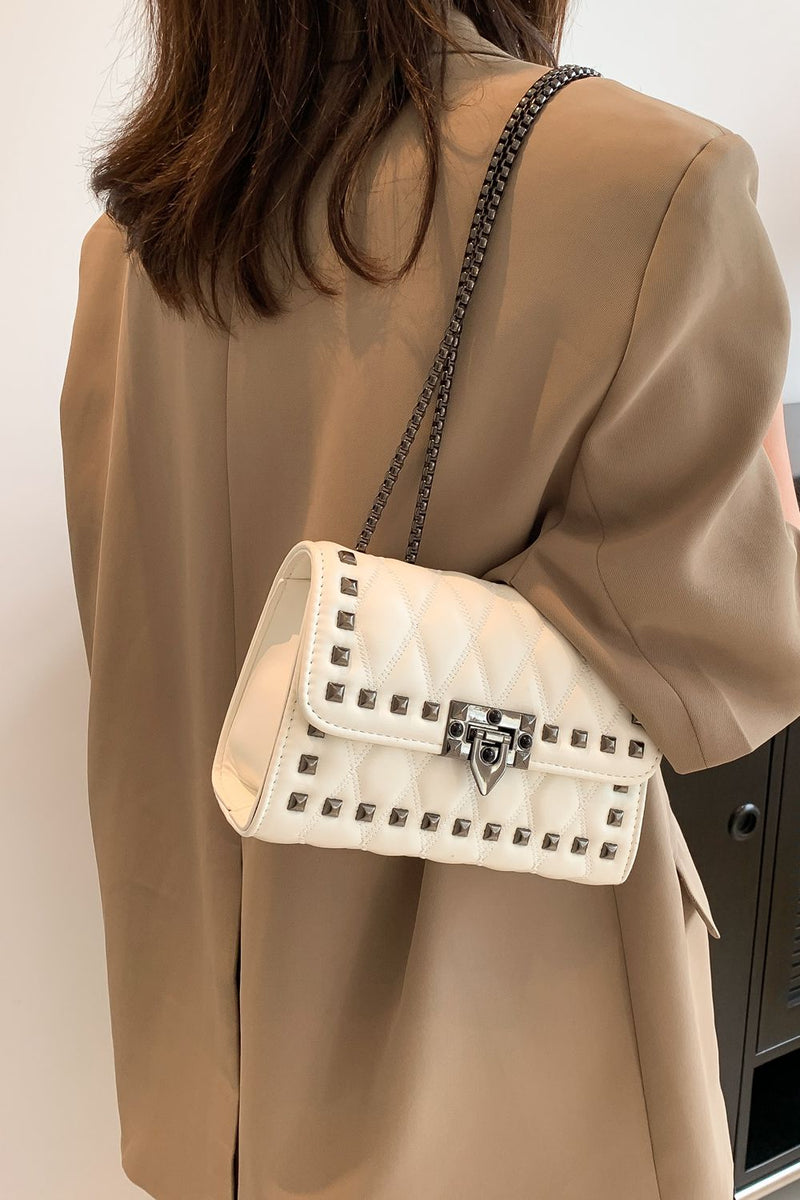 "Edgy and Chic: Studded Leather Crossbody Bag at Burkesgarb