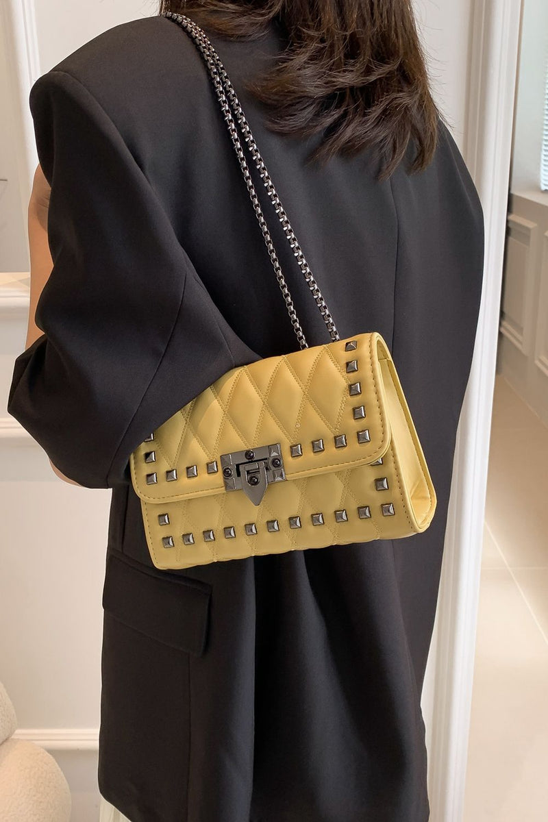 "Edgy and Chic: Studded Leather Crossbody Bag at Burkesgarb