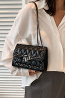 "Edgy and Chic: Studded Leather Crossbody Bag at Burkesgarb