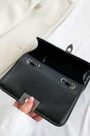 "Edgy and Chic: Studded Leather Crossbody Bag at Burkesgarb