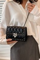 "Edgy and Chic: Studded Leather Crossbody Bag at Burkesgarb