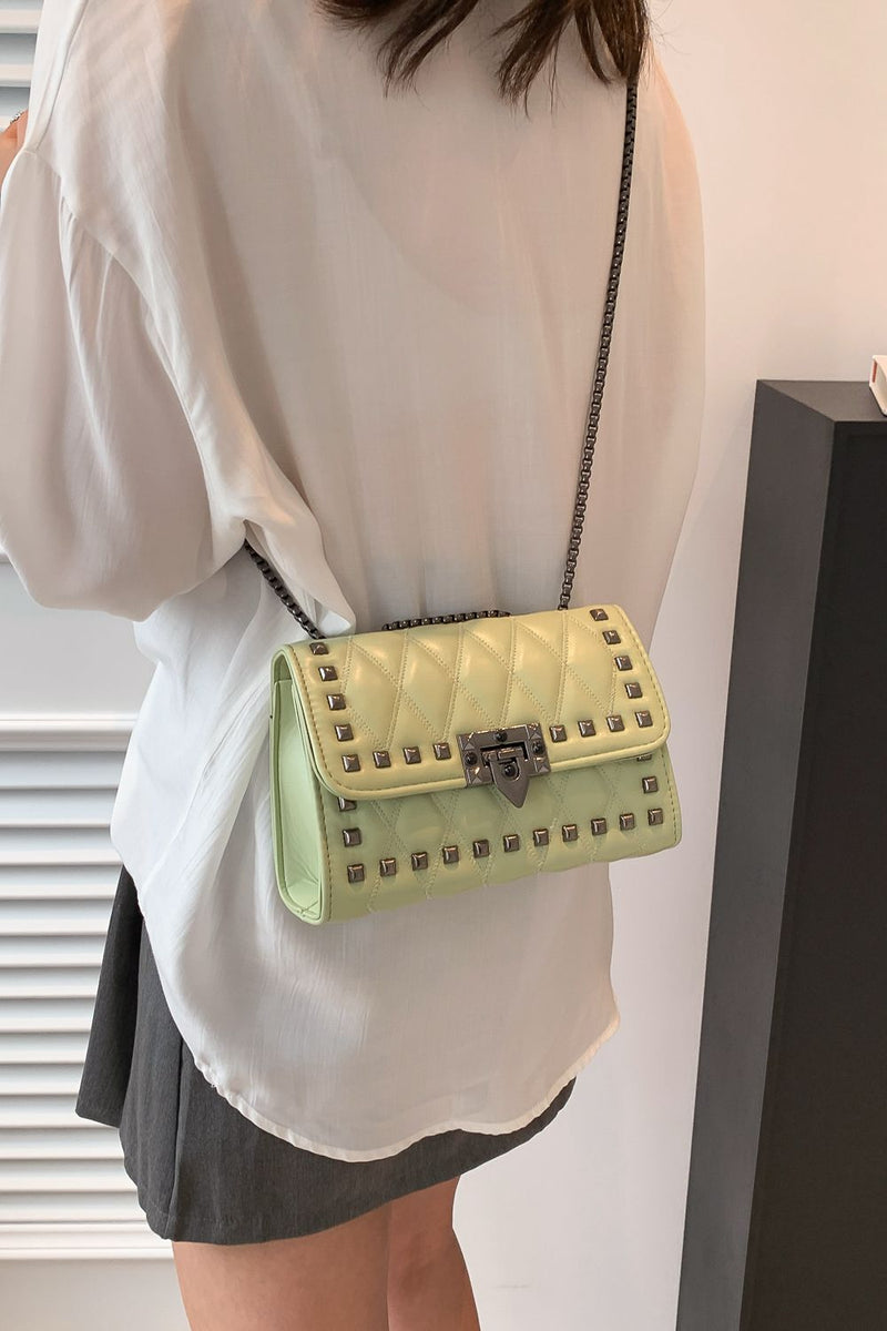 "Edgy and Chic: Studded Leather Crossbody Bag at Burkesgarb