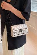 "Edgy and Chic: Studded Leather Crossbody Bag at Burkesgarb