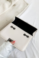 "Edgy and Chic: Studded Leather Crossbody Bag at Burkesgarb