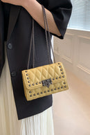 "Edgy and Chic: Studded Leather Crossbody Bag at Burkesgarb